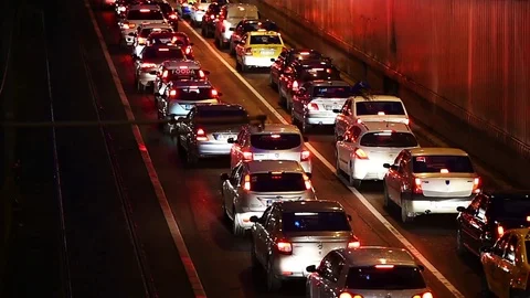 Car lights are seen in a night scene with urban traffic congestion Stock Footage 73276111