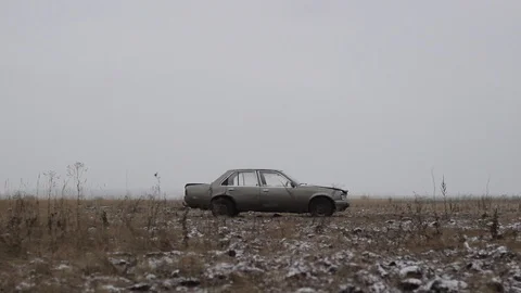 The car lights up in the field. The engine is smoking on the car. Stock Footage 101529479