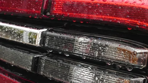 Car lights in raindrops close-up. Raindrops run down the headlights makr plan Stock Footage 161246966