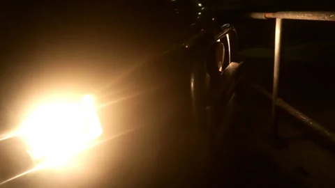 Car lights shines in the dark Stock Footage 103044796