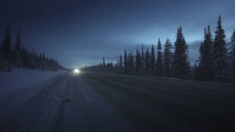 Car lights in winter forest Video stock 83636311