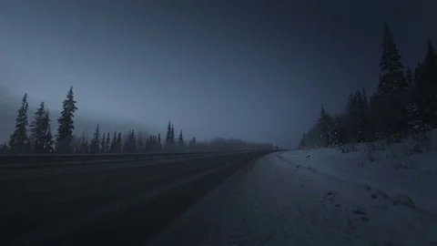 Car lights in winter forest Video stock 84838727
