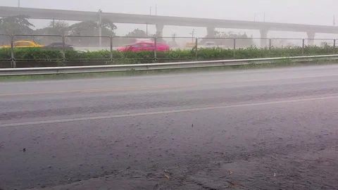 Car on the main road in the raining day Stock Footage 69812481