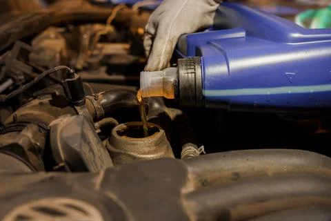 Car Maintenance: Adding Engine Oil to a Vehicle 写真素材