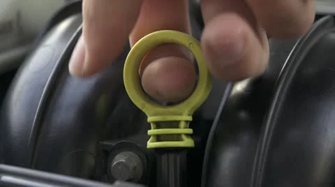 Car maintenance - Checking oil in car engine with a dipstick Stock Footage 22330554