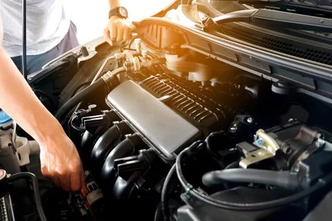 Car maintenance technician He is checking the auto engine, car inspection cen Stock Photos