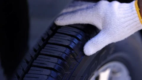 A car maintenance worker checking the quality of the tires Stock Footage 152747949