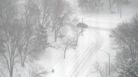 Car making right-hand turn during heavy snowfall Stock Footage 48551573
