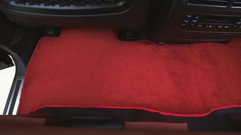 Car mat changes color different color options for car floor covering Stock Footage 258379609