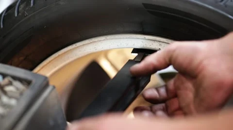Car mechanic balancing wheel Stock Footage 54234705