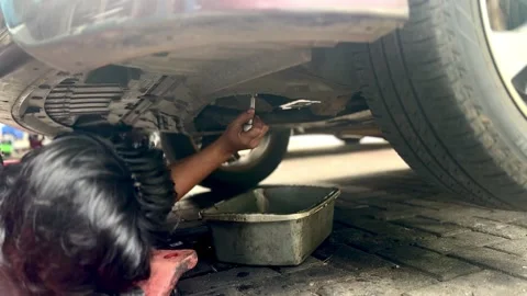 Car Mechanic Changing Engine Oil in Workshop Stock Footage 337924114