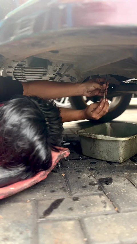Car Mechanic Changing Engine Oil in Workshop Stock Footage 337924116