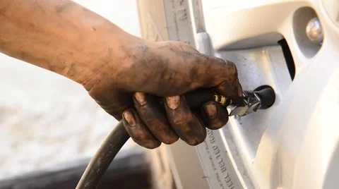 Car mechanic checking pressure and inflating car tire. Stock-Footage 61044072