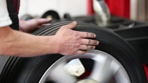 Car mechanic checking tire on balancing machine Stock Footage 54234425
