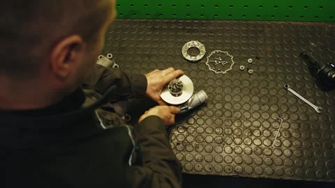 Car mechanic completes turbine setup and repair Stock Footage 285642462