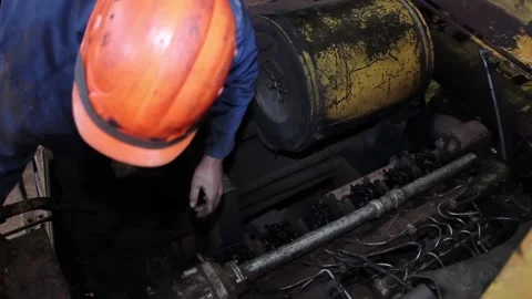 A car mechanic in a protective helmet does his job, 스톡 동영상 124576582