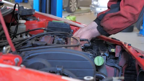 Car mechanic repairs a car Stock Footage 128763904