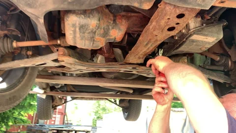 A car mechanic repairs a car using a wrench. Stock Footage 316770687