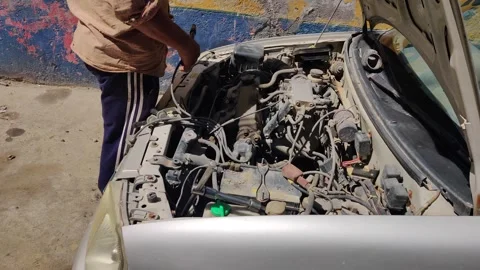 Car mechanic repairs the engine, car service Stock-Footage 256975712