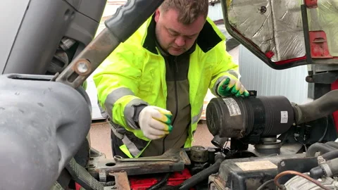 Car mechanic repairs a forklift. Stock Footage 306078867