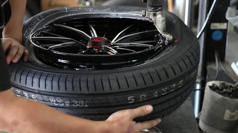 Car mechanic replace tire on wheel in auto repair service. Stock Footage 102665118