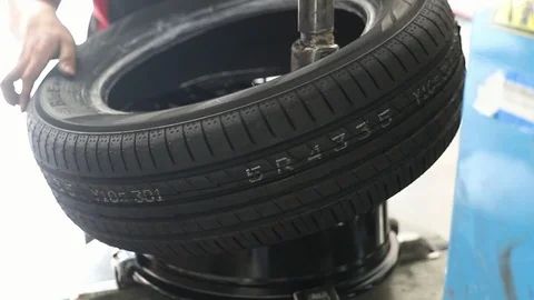 Car mechanic replace tire on wheel in auto repair service. Stock Footage 104716845