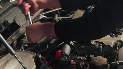 Car mechanic uses torque wrench to loosen ignition coils . Close up of hands Stock Footage 337879321