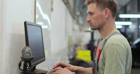 Car mechanic using computer to run diagnostic software Stock Footage 341870881