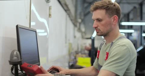 Car mechanic using computer to run diagnostic software for troubleshooting .. Stock Photos