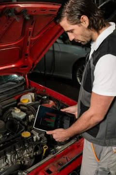 Car mechanic using digital tablet Stock Photos