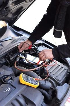 Car mechanic using an electronic device Stock Photos