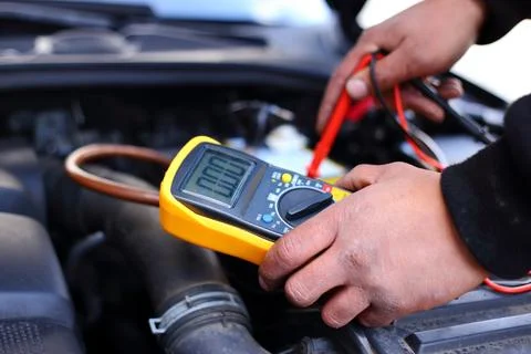 Car mechanic using an electronic device Stock Photos