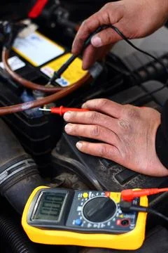 Car mechanic using an electronic device Stock Photos