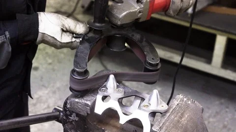 Car mechanic using grinding Power Tool with emery paper polishing car part Stock Footage 106103869