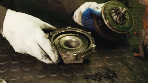 Car mechanic in white gloves disassembles inside the car engine part turbine  Stock Footage 285641991