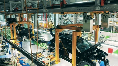 Car mechanics assembling vehicles on a production line Stock-Footage 144547678