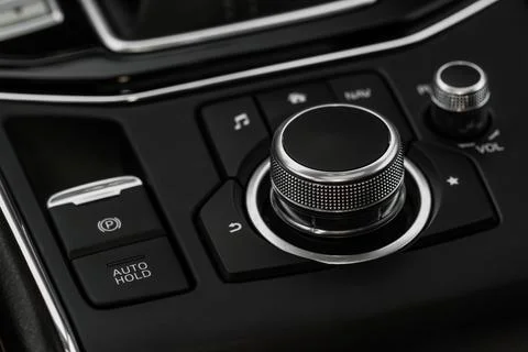 Car media controller close up. Modern car media and navigation control button Photos