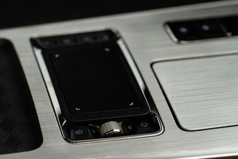 Car media controller close up. Modern car media and navigation control button Photos
