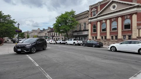 Car merging into traffic on a small town street 4K Stock Footage 313460196