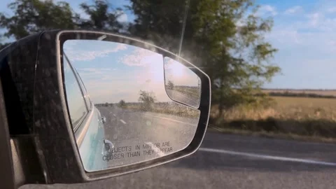 Car mirror with reflection of the road close-up. Traveling by car. Side mirror Stock Footage 309006397
