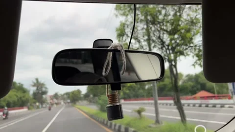 Car mirror when the car is driving on the road Stock Footage 169385011