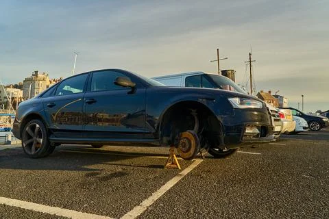 A car missing the front right wheel Stock Photos