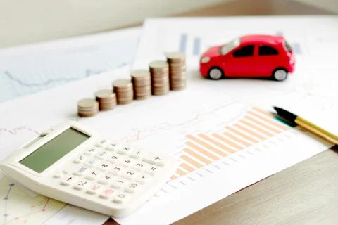 With Car Model And Stack Of Coins On Desk Stock Photos