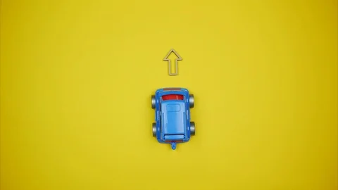 The car model moves behind the arrow on a bright background. Stop motion Stock Footage 104356284