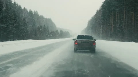 Car motion on road surrounded by forest in winter Video stock 196976953