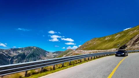 Car on Mountain Pass under Deep Blue Sky Stock Photos