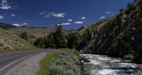 Car on a mountain road alongside a stream 4k 24fps rev 2 Stock Footage 77306766
