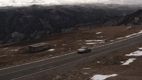 Car in the mountains of the Caucasus in winter. An electric car drives through Stock Footage