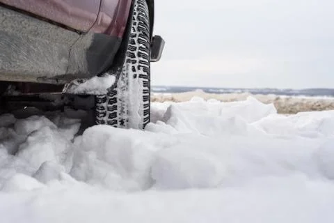 Car with mounted snow chains in wintry environment Stock Photos