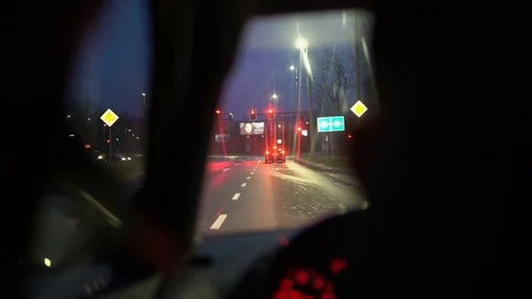 A car moves and slows down in front of a red traffic light 動画素材 126995175